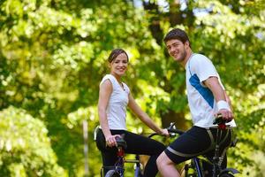 Happy couple ridine bicycle outdoors photo