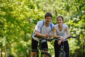 Happy couple ridine bicycle outdoors photo