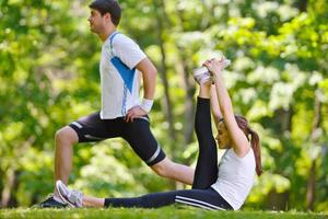 Couple doing stretching exercise  after jogging photo