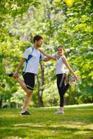 Couple doing stretching exercise  after jogging photo