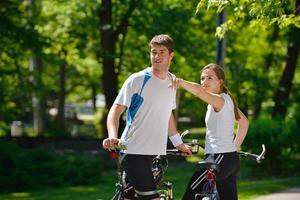 Happy couple riding bicycle outdoors photo