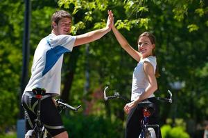 Happy couple ridine bicycle outdoors photo