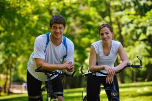 Happy couple ridine bicycle outdoors photo