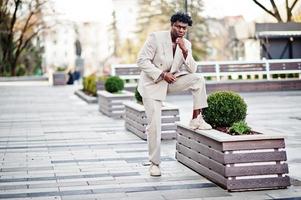 Stylish afro man in beige old school suit. Fashionable young African male in casual jacket on bare torso. photo