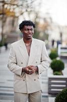 Stylish afro man in beige old school suit. Fashionable young African male in casual jacket on bare torso. photo