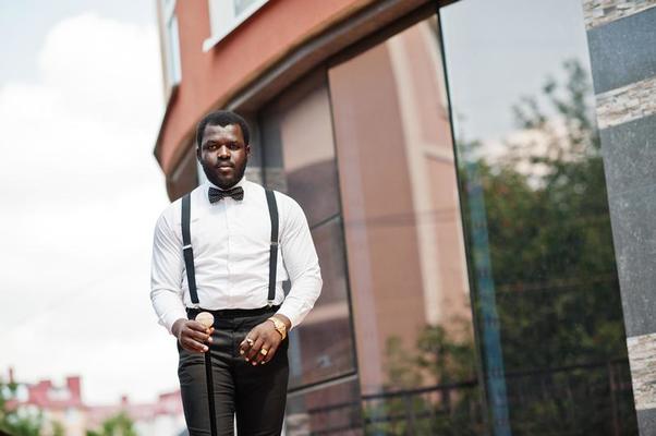 Handsome fashionable african american man in formal wear, bow