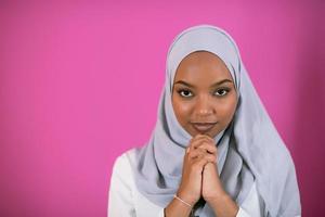 African Muslim woman makes traditional prayer to God photo