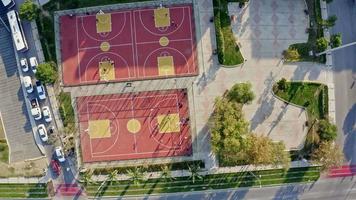 Aerial Shot Of Basketball Court. This stock video shows an aerial shot of people playing basketball on a court.