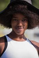 Close up portrait of a beautiful young african american woman smiling and looking up photo