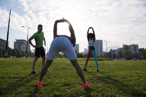 multiethnic group of people stretching in city park photo