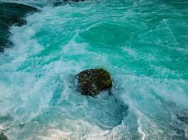 single stone in wild river photo