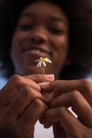 portrait of African American girl with a flower in her hand photo