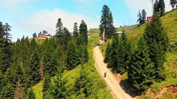 Elderly fit man walk uphill to home village in nature in Georgia countryside, Bakhmaro village. Retirement and lifestyle concept in caucasus video