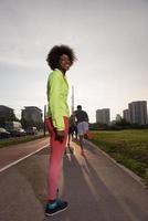 Portrait of sporty young african american woman running outdoors photo