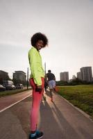 Portrait of sporty young african american woman running outdoors photo