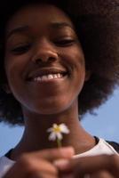 portrait of African American girl with a flower in her hand photo