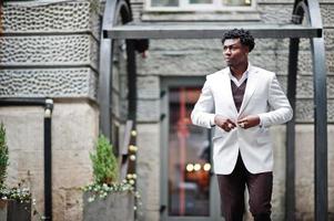 Thoughtful young handsome african american gentleman in formalwear. Black stylish model man in white jacket. photo