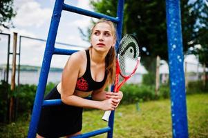 Beautiful sport woman tennis player with racket in sportswear costume. photo