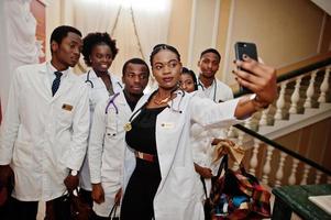 Group of african doctors students inside medical university making selfie at phone. photo