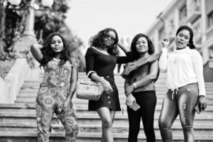 Group of four african american girls walking at stairs of city. photo