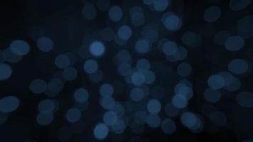 Loop  blue bokeh bubbles floating on dark background video