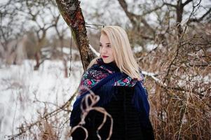 Blonde girl with hand embroidered scarf posed at winter day. Women's handkerchief. photo