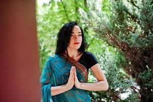 Portrait of beautiful indian brumette girl or hindu woman model. Traditional Indian costume lehenga choli. photo