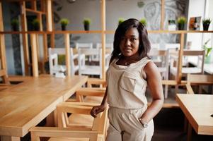 Stylish african american girl posed at modern cafe. photo