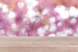 brown wood table top on bokeh abstract pink background - can be used for montage or display your products photo