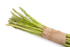 uncooked green asparagus tied with twine from above isolated on white background photo