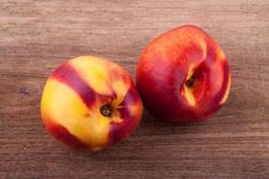 nectarines on wooden table photo