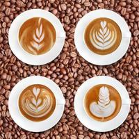 Latte art coffee on roasted coffee beans background photo