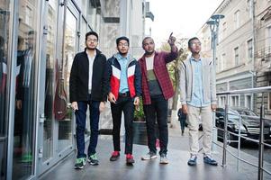 Group of four indian teen male students. Classmates spend time together. photo