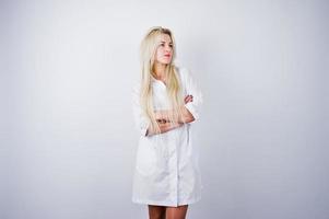 Attractive blonde female doctor or nurse  in lab coat isolated on white background. photo