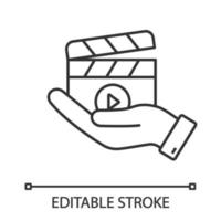 Movie release linear icon. Video production. Thin line illustration. Cinematography. Hand holding clapperboard. Film director. Contour symbol. Vector isolated outline drawing. Editable stroke