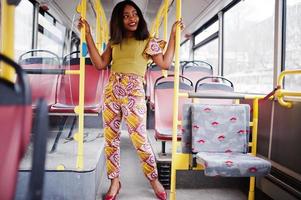 Young stylish african american woman riding on a bus. photo