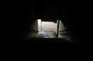 Industrial interior of an old abandoned factory. Stairs on shadow. Scary concept. photo