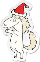 sticker cartoon of a horse wearing santa hat vector