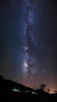 Silhouette of Tree and Milky Way at Phu Hin Rong Kla National Park,Phitsanulok Thailand .Long exposure photograph.With grain photo