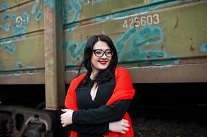 Brunette girl wear in black with glasses in railway station. photo