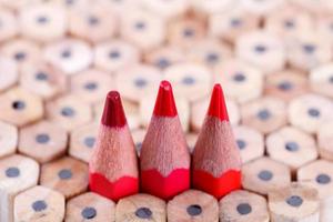 three sharpened red pencil among many ones photo