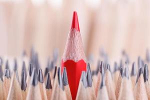 One sharpened red pencil among many ones photo