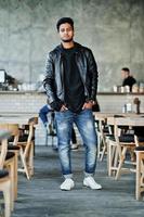 Portrait of stylish and casual young asian man wear on leather jacket spending time at cafe. photo