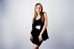 Girl model in black wear posed at studio on white background. photo