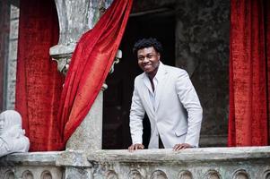 Thoughtful young handsome african american gentleman in formalwear. Black stylish model man in white jacket. photo