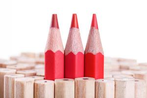 three sharpened red pencil among many ones photo