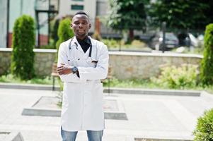 African american doctor male at lab coat with stethoscope outdoor. photo
