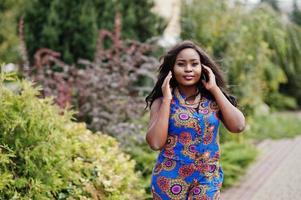 African american girl in coloured clothes posed outdoor. Fashionable black woman. photo