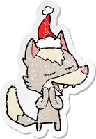 distressed sticker cartoon of a wolf laughing wearing santa hat vector