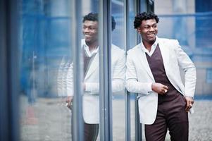 Thoughtful young handsome african american gentleman in formalwear. Black stylish model man in white jacket. photo